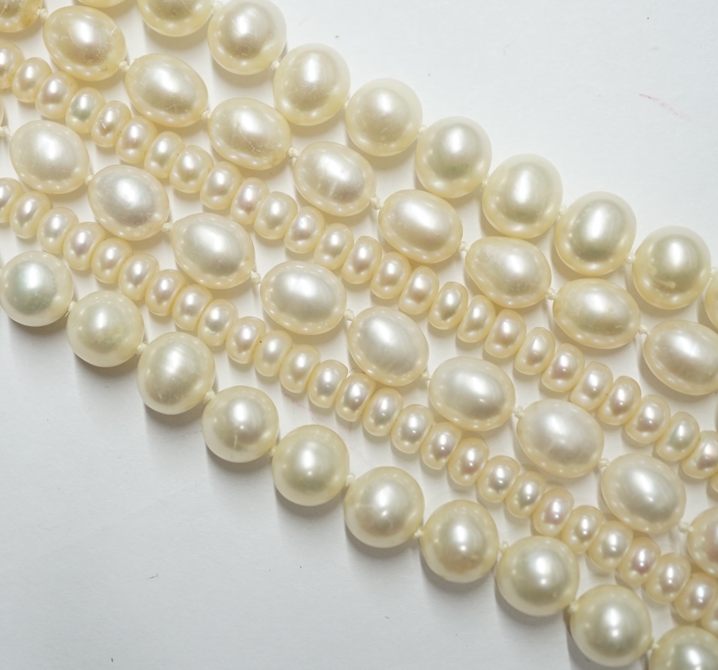 Three assorted modern cultured pearl necklaces, two with 9k clasps, longest 64cm. Condition - fair